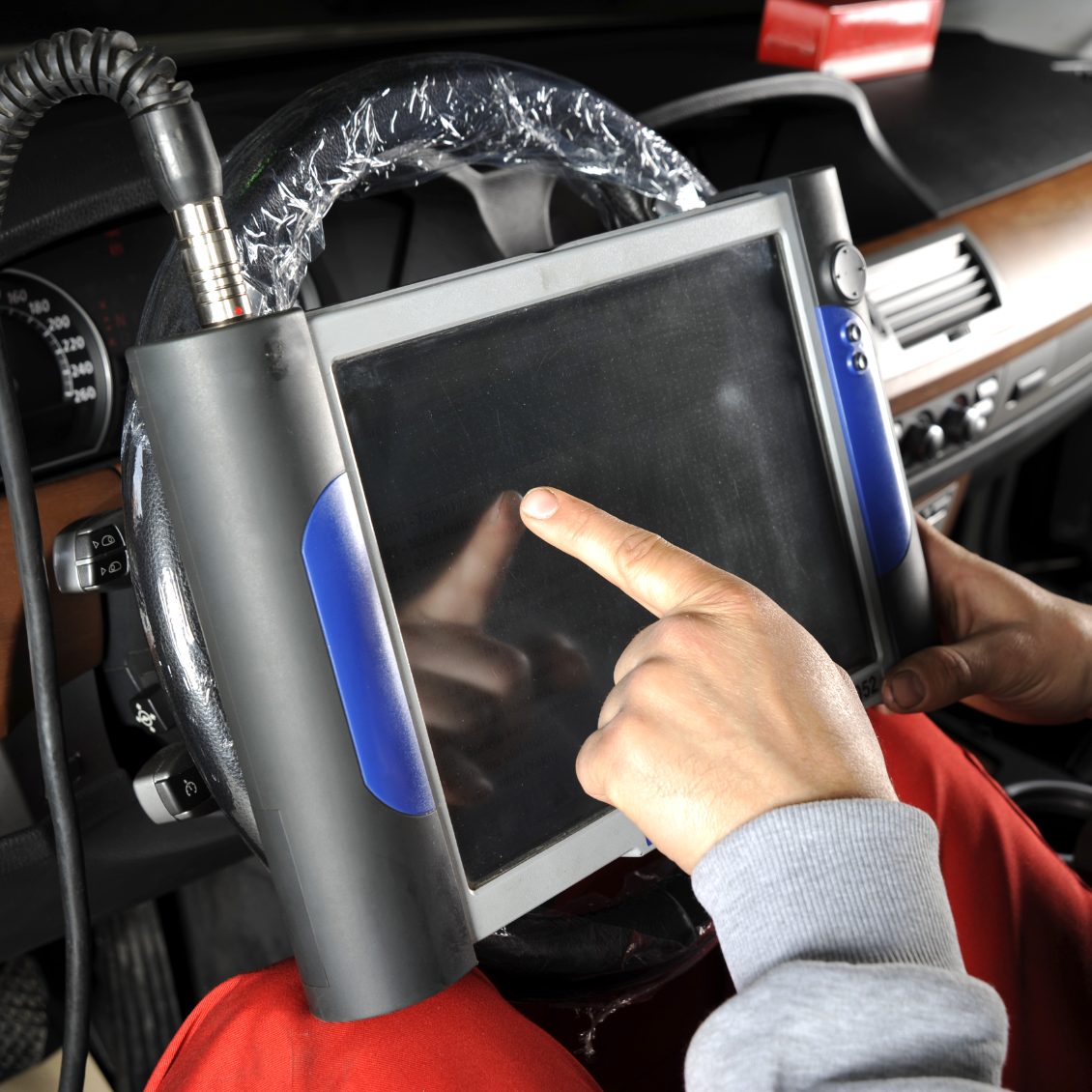 Mobile technician using diagnostic machine in the forest of dean